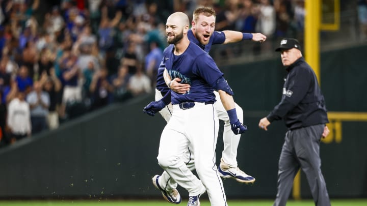 Seattle Mariners right fielder Mitch Haniger (front) celebrates with first baseman Luke Raley after hitting a walk-off double against the Detroit Tigers on Thursday at T-Mobile Park.