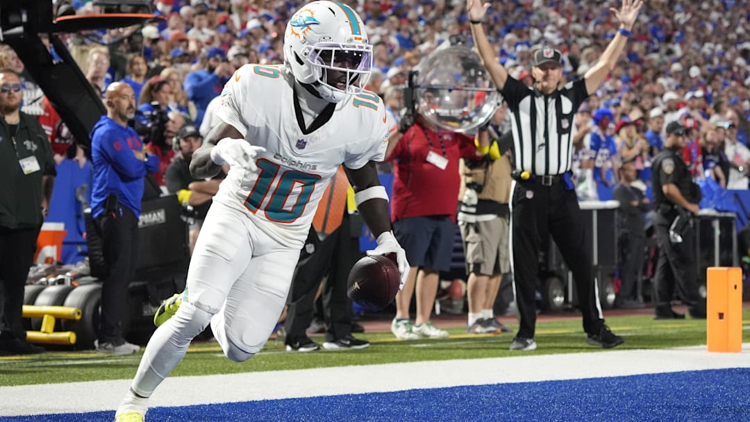 Sep 18, 2025; Orchard Park, New York, USA;  Miami Dolphins wide receiver Tyreek Hill (10) scores a touchdown against the Buffalo Bills in the fourth quarter at Highmark Stadium. Mandatory Credit: Gregory Fisher-Imagn Images