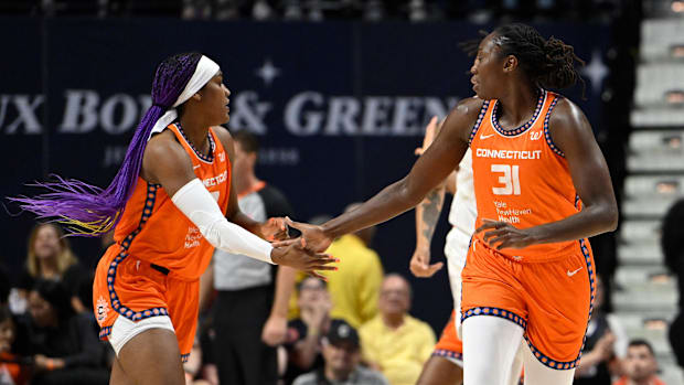 Connecticut Sun center Tina Charles celebrates a basket with forward Aaliyah Edwards.