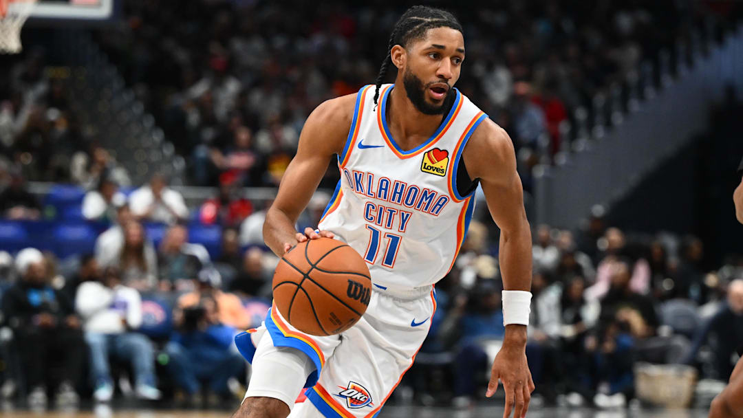 Mar 21, 2026; Washington, District of Columbia, USA; Oklahoma City Thunder guard Isaiah Joe (11) dribbles past Washington Wizards guard Bub Carrington (7) during the second half at Capital One Arena. Mandatory Credit: Brad Mills-Imagn Images