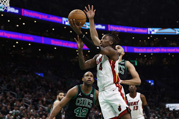 Miami Heat guard Delon Wright (4) goes to the basket against Boston Celtics defenders in a 2023-24 season game at TD Garden.