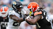 Sep 15, 2024; Jacksonville, Florida, USA; Cleveland Browns running back D'Onta Foreman (27) stiff arms Jacksonville Jaguars safety Antonio Johnson (26) in the fourth quarter  at EverBank Stadium. Mandatory Credit: Jeremy Reper-Imagn Images