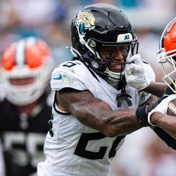 Sep 15, 2024; Jacksonville, Florida, USA; Cleveland Browns running back D'Onta Foreman (27) stiff arms Jacksonville Jaguars safety Antonio Johnson (26) in the fourth quarter  at EverBank Stadium. Mandatory Credit: Jeremy Reper-Imagn Images