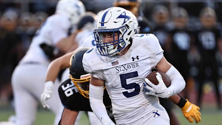 St. Xavier running back carries the ball during their football game against Moeller Friday, Sept. 19, 2025.