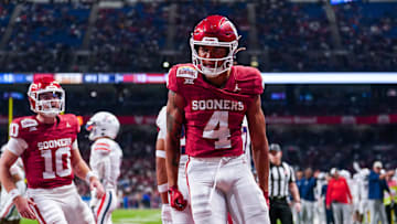Dec 28, 2023; San Antonio, TX, USA;  Oklahoma Sooners wide receiver Nic Anderson (4) celebrates a touchdown catch in the first half against the Arizona Wildcats at Alamodome. Mandatory Credit: Daniel Dunn-Imagn Images