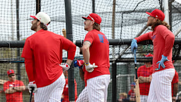 Philadelphia Phillies first base Bryce Harper, second base Bryson Stott and third base Alec Bohm take batting practice during spring training workouts at BayCare Ballpark