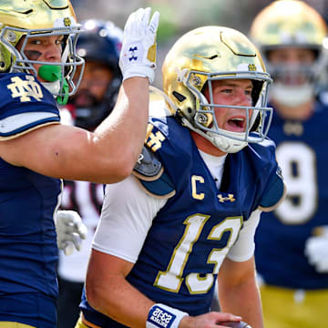 Sep 7, 2024; South Bend, Indiana, USA; Notre Dame Fighting Irish quarterback Riley Leonard (13) celebrates after scoring a touchdown in the first quarter against the Northern Illinois Huskies at Notre Dame Stadium. 