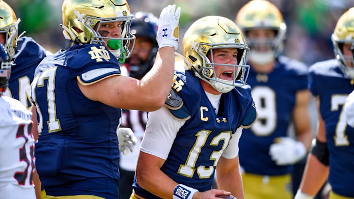 Sep 7, 2024; South Bend, Indiana, USA; Notre Dame Fighting Irish quarterback Riley Leonard (13) celebrates after scoring a touchdown in the first quarter against the Northern Illinois Huskies at Notre Dame Stadium. 