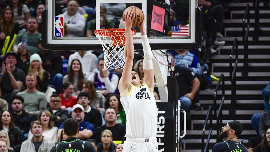 Nov 25, 2023; Salt Lake City, Utah, USA; Utah Jazz center Walker Kessler (24) dunks over New Orleans Pelicans guard Jordan Hawkins (24) and forward/center Larry Nance Jr. (22) during the second half at Delta Center.