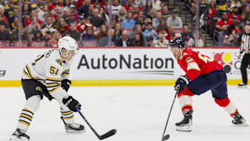 Nov 22, 2023; Sunrise, Florida, USA; Boston Bruins center Matthew Poitras (51) moves the puck against Florida Panthers defenseman Brandon Montour (62) during the first period at Amerant Bank Arena. Mandatory Credit: Sam Navarro-Imagn Images