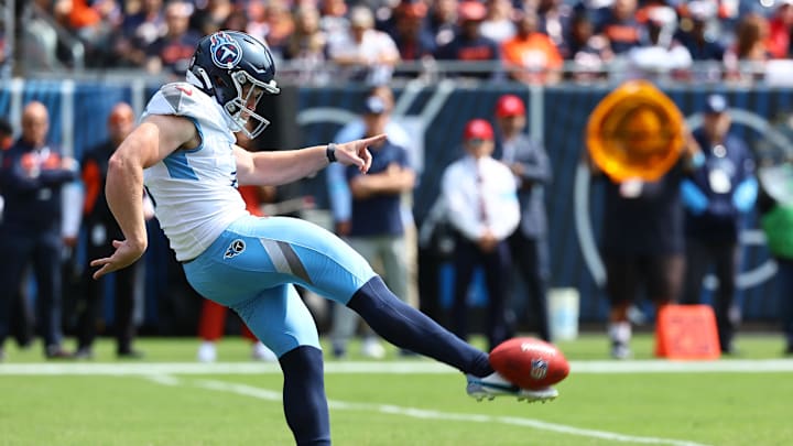 Sep 8, 2024; Chicago, Illinois, USA; Tennessee Titans punter Ryan Stonehouse (4) punts the ball against the Chicago Bears during the first quarter at Soldier Field. Mandatory Credit: Mike Dinovo-Imagn Images