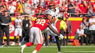 Sep 15, 2024; Kansas City, Missouri, USA; Cincinnati Bengals tight end Erick All Jr. (83) catches a pass as Kansas City Chiefs linebacker Nick Bolton (32) makes the tackle during the first half at GEHA Field at Arrowhead Stadium. Mandatory Credit: Denny Medley-Imagn Images