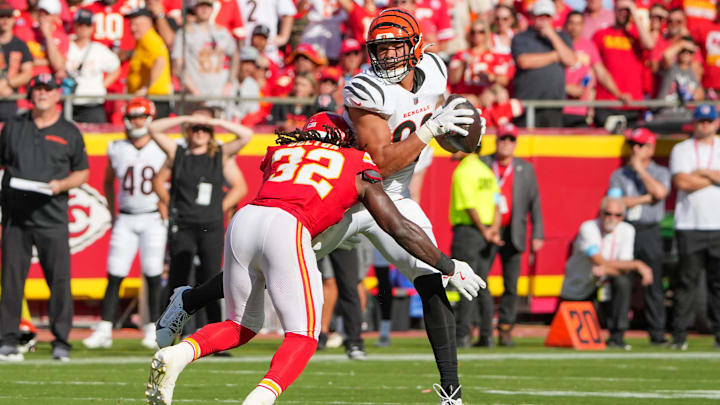 Sep 15, 2024; Kansas City, Missouri, USA; Cincinnati Bengals tight end Erick All Jr. (83) catches a pass as Kansas City Chiefs linebacker Nick Bolton (32) makes the tackle during the first half at GEHA Field at Arrowhead Stadium. Mandatory Credit: Denny Medley-Imagn Images