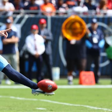 Sep 8, 2024; Chicago, Illinois, USA; Tennessee Titans punter Ryan Stonehouse (4) punts the ball against the Chicago Bears during the first quarter at Soldier Field. 