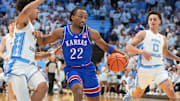 Nov 7, 2025; Chapel Hill, North Carolina, USA;  Kansas Jayhawks guard Darryn Peterson (22) with the ball as North Carolina Tar Heels guard Seth Trimble (7) and guard Kyan Evans (0) defend in the first half at Dean E. Smith Center. Mandatory Credit: Bob Donnan-Imagn Images