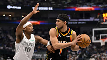 Dallas Mavericks guard Brandon Williams (10) and Phoenix Suns guard Devin Booker (1) in action during the game between the Dallas Mavericks and the Phoenix Suns at American Airlines Center. Mandatory Credit: Jerome Miron-Imagn Images