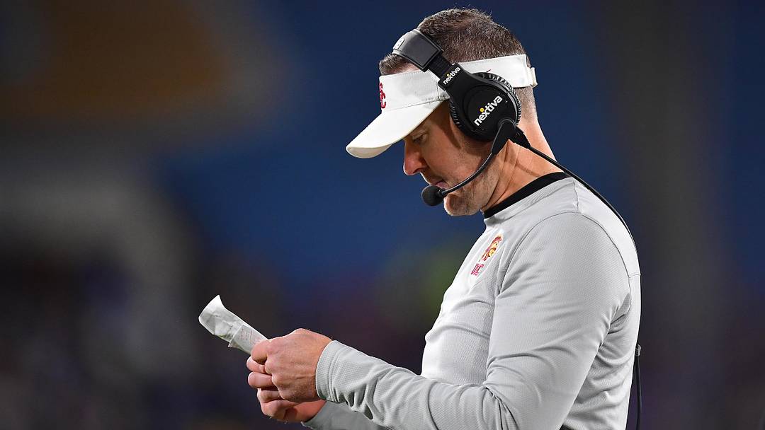 Nov 19, 2022; Pasadena, California, USA; Southern California Trojans head coach Lincoln Riley reviews game notes during the first half at the Rose Bowl. Mandatory Credit: Gary A. Vasquez-Imagn Images