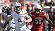 Oct 4, 2025; Louisville, Kentucky, USA; Virginia Cavaliers quarterback Chandler Morris (4) looks to pass against the Louisville Cardinals during the second quarter at L&N Federal Credit Union Stadium. Mandatory Credit: Jamie Rhodes-Imagn Images