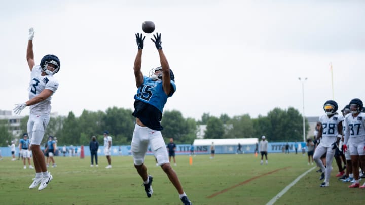 Tennessee Titans wide receiver Nick Westbrook-Ikhine (15) goes up for a catch over cornerback Caleb Farley (3) during training camp at Ascension Saint Thomas Sports Park Wednesday, Aug. 7, 2024.