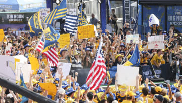 Aug 31, 2024; Morgantown, West Virginia, USA; Fans cheer during the Big Noon Kickoff show outside of Mountaineer Field at Milan Puskar Stadium. 