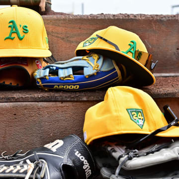 Mar 6, 2024; Tempe, Arizona, USA;  General view of Oakland Athletics hats and gloves prior to a spring training game against the Los Angeles Angels at Tempe Diablo Stadium. Mandatory Credit: Matt Kartozian-USA TODAY Sports
