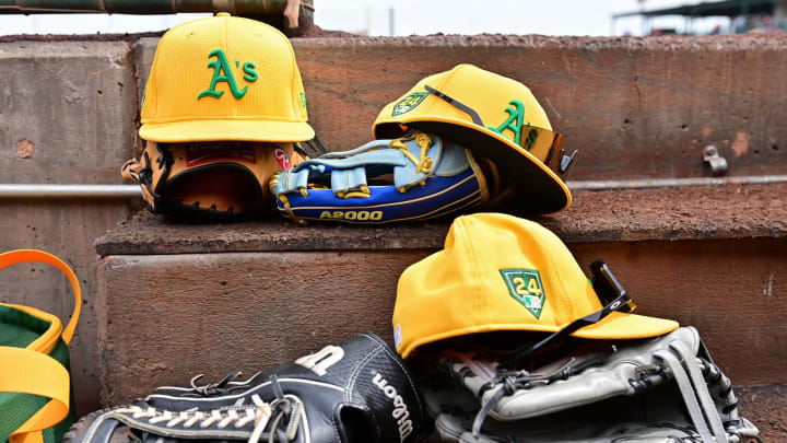 Mar 6, 2024; Tempe, Arizona, USA;  General view of Oakland Athletics hats and gloves prior to a spring training game against the Los Angeles Angels at Tempe Diablo Stadium. Mandatory Credit: Matt Kartozian-USA TODAY Sports