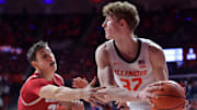 Dec 10, 2024; Champaign, Illinois, USA;  Illinois Fighting Illini guard Kasparas Jakucionis (32) looks to pass as Wisconsin Badgers guard Jack Janicki (33) pressures him during the second half at State Farm Center. Mandatory Credit: Ron Johnson-Imagn Images