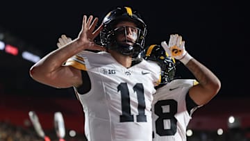 Sep 19, 2025; Piscataway, New Jersey, USA; Iowa Hawkeyes quarterback Mark Gronowski (11) reacts after scoring a rushing touchdown during the fourth quarter against the Rutgers Scarlet Knights at SHI Stadium. Mandatory Credit: Vincent Carchietta-Imagn Images