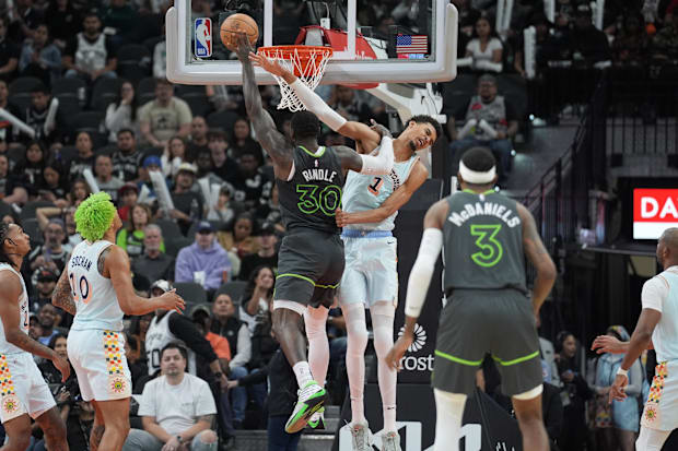 Minnesota Timberwolves forward Julius Randle (30) fends off San Antonio Spurs center Victor Wembanyama (1) in the second half