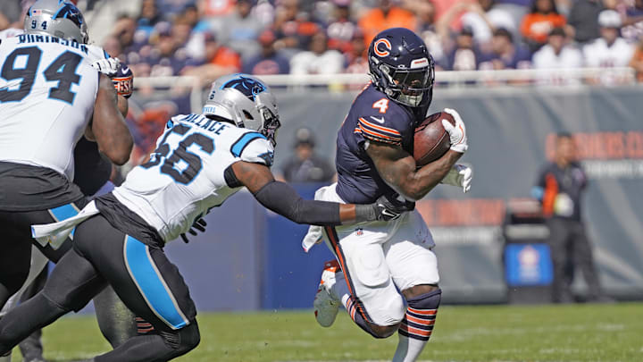 Oct 6, 2024; Chicago, Illinois, USA; Chicago Bears running back D'Andre Swift (4) runs the ball as Carolina Panthers linebacker Trevin Wallace (56) tackles him during the first half at Soldier Field. Mandatory Credit: David Banks-Imagn Images