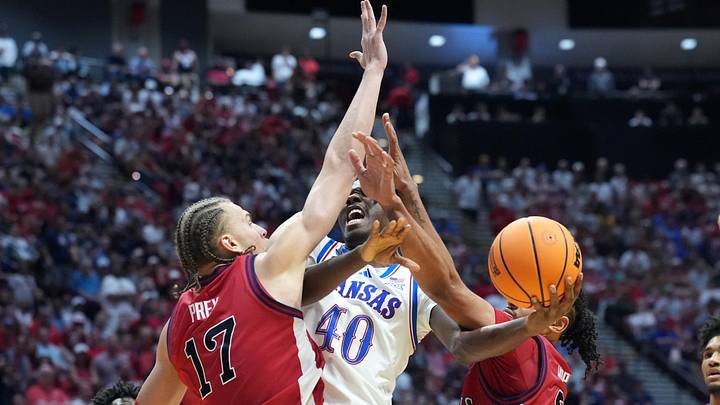 Mar 22, 2026; San Diego, CA, USA; Kansas Jayhawks forward Flory Bidunga (40) shoots against St. John's Red Storm forward Rubén Prey (17) and forward Bryce Hopkins (23) in the second half during a second round game of the men's 2026 NCAA Tournament at Viejas Arena. Mandatory Credit: Kirby Lee-Imagn Images