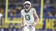 Nov 16, 2024; Morgantown, West Virginia, USA; Baylor Bears quarterback Sawyer Robertson (13) celebrates after a touchdown during the second quarter against the West Virginia Mountaineers at Mountaineer Field at Milan Puskar Stadium. Mandatory Credit: Ben Queen-Imagn Images