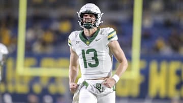 Nov 16, 2024; Morgantown, West Virginia, USA; Baylor Bears quarterback Sawyer Robertson (13) celebrates after a touchdown during the second quarter against the West Virginia Mountaineers at Mountaineer Field at Milan Puskar Stadium. Mandatory Credit: Ben Queen-Imagn Images