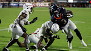 Sep 26, 2025; Charlottesville, Virginia, USA; Virginia Cavaliers running back J'Mari Taylor (3) carries the ball as Florida State Seminoles defensive back Ja'Bril Rawls (11) tackleds in the second overtime at Scott Stadium. Mandatory Credit: Geoff Burke-Imagn Images