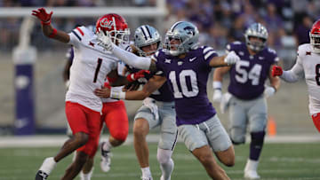 Kansas State Wildcats wide receiver Keagan Johnson (10) blocks Arizona Wildcats defensive back Tacario Davis (1) from reaching Kansas State Wildcats quarterback Avery Johnson (2) during the first quarter of the game at Bill Snyder Family Stadium Friday, September 13, 2024.