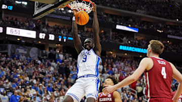 Mar 29, 2025; Newark, NJ, USA; Duke Blue Devils center Khaman Maluach (9) dunks the ball against Alabama Crimson Tide forward Grant Nelson (4) during the second half in the East Regional final of the 2025 NCAA tournament at Prudential Center. 