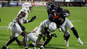 Sep 26, 2025; Charlottesville, Virginia, USA; Virginia Cavaliers running back J'Mari Taylor (3) carries the ball as Florida State Seminoles defensive back Ja'Bril Rawls (11) tackleds in the second overtime at Scott Stadium. Mandatory Credit: Geoff Burke-Imagn Images