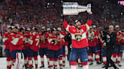 Jun 17, 2025; Sunrise, Florida, USA; Florida Panthers left wing Matthew Tkachuk (19) hoist the Stanley Cup after game six of the 2025 Stanley Cup Final against the Edmonton Oilers at Amerant Bank Arena. Mandatory Credit: Jim Rassol-Imagn Images