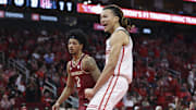 Florida State Seminoles guard Cam Miles looks on as Houston Cougars guard Kingston Flemings celebrates after scoring a basket during the first half at Toyota Center.