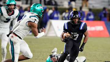 Ramsay   s Jayden Martin runs the ball and is pursued by Gulf Shores' Jamichael Garrett (7) during the 5A AHSAA State Championship Game in Bryant-Denny Stadium Thursday, Dec. 7, 2023.