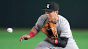 Mar 15, 2025; Bunkyo, Tokyo, Japan; Yomiuri Giants first baseman Kazuma Okamoto (25) fields a ground ball against the Los Angeles Dodgers during the fifth inning at Tokyo Dome. Mandatory Credit: Darren Yamashita-Imagn Images