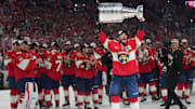 Jun 17, 2025; Sunrise, Florida, USA; Florida Panthers left wing Matthew Tkachuk (19) hoist the Stanley Cup after game six of the 2025 Stanley Cup Final against the Edmonton Oilers at Amerant Bank Arena. Mandatory Credit: Jim Rassol-Imagn Images