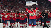 Jun 17, 2025; Sunrise, Florida, USA; Florida Panthers left wing Matthew Tkachuk (19) hoist the Stanley Cup after game six of the 2025 Stanley Cup Final against the Edmonton Oilers at Amerant Bank Arena. Mandatory Credit: Jim Rassol-Imagn Images