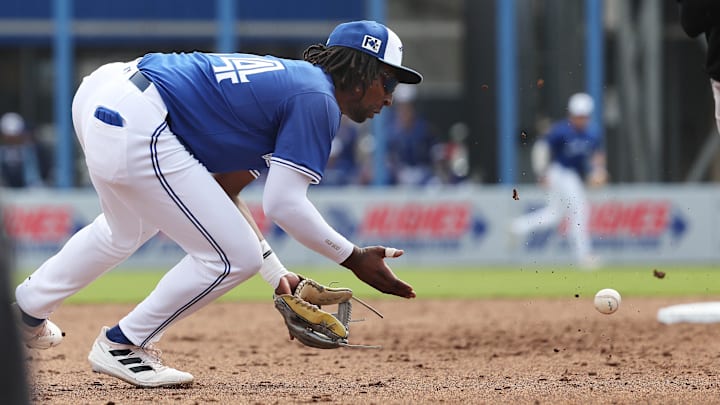 Feb 22, 2025: Toronto Blue Jays infielder Charles McAdoo (84) fields the ball before throwing to first base for an out during the fifth inning against the New York Yankees at TD Ballpark.