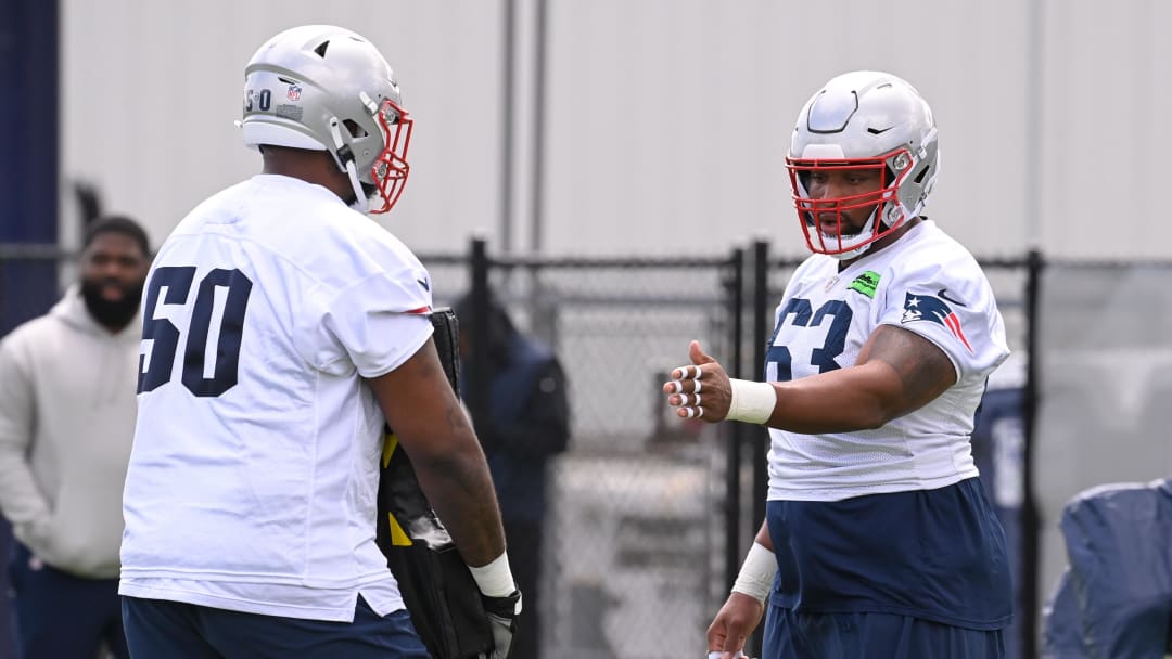 May 11, 2024; Foxborough, MA, USA; New England Patriots guard Layden Robinson (63) works with tackle Hyrin White (50) at the New England Patriots rookie camp at Gillette Stadium.  Mandatory Credit: Eric Canha-USA TODAY Sports
