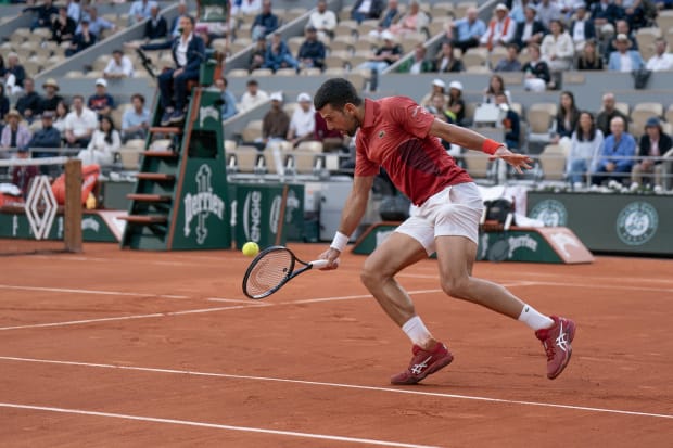 Novak Djokovic returns a shot during his match at Roland Garros.
