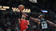 Apr 6, 2025; Portland, Oregon, USA; Portland Trail Blazers shooting guard Matisse Thybulle (4) shoots against San Antonio Spurs center Bismack Biyombo (18) during the second half at Moda Center. Mandatory Credit: Soobum Im-Imagn Images