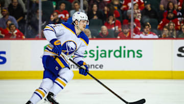 Jan 23, 2025; Calgary, Alberta, CAN; Buffalo Sabres defenseman Bowen Byram (4) skates with the puck against the Calgary Flames during the second period at Scotiabank Saddledome. Mandatory Credit: Sergei Belski-Imagn Images