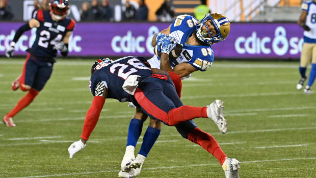 Nov 19, 2023; Hamilton, Ontario, CAN; Winnipeg Blue Bombers wide receiver Kenny Lawler (89) is tackled by Montreal Alouettes linebacker Tyrice Beverette (26) after catching a pass in the first half at Tim Hortons Field. Mandatory Credit: Dan Hamilton-USA TODAY Sports