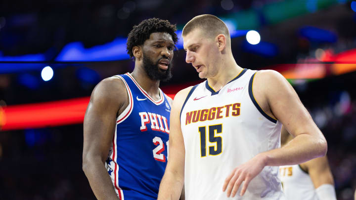 Jan 16, 2024; Philadelphia, Pennsylvania, USA; Philadelphia 76ers center Joel Embiid (21) glances at Denver Nuggets center Nikola Jokic (15) during a break in action in the third quarter at Wells Fargo Center. 